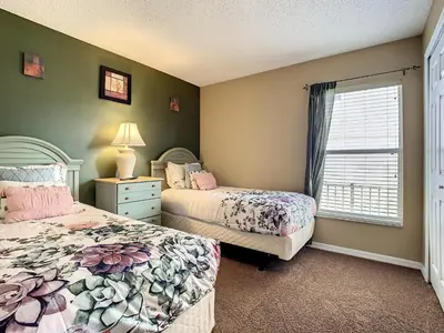 a bedroom with two beds and a window at Emerald Island Resort 4 bed 3 bath with pool/spa in Kissimmee
