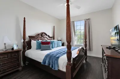 a bedroom with a large bed with blue pillows at Windsor Palms 3 bed Condo in Gated Resort in Kissimmee