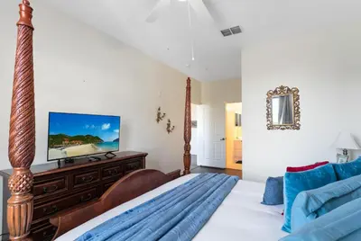 a bedroom with a bed and a television on a dresser at Windsor Palms 3 bed Condo in Gated Resort in Kissimmee