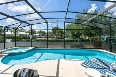 a large swimming pool with a glass roof at Four Bedroom/3 Bath South Facing Pool/Spa Villa in Kissimmee