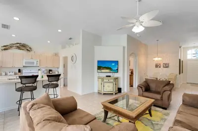 a living room with a couch and a table at Four Bedroom/3 Bath South Facing Pool/Spa Villa in Kissimmee
