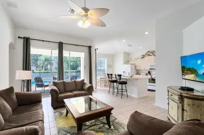 a living room with a couch and a table at Four Bedroom/3 Bath South Facing Pool/Spa Villa in Kissimmee