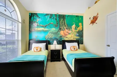 two beds in a room with a painting on the wall at Fantastic Resort 5BR House - South Facing Pool/Spa in Kissimmee