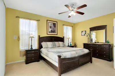 a bedroom with a bed and a ceiling fan at Fantastic Resort 5BR House - South Facing Pool/Spa in Kissimmee