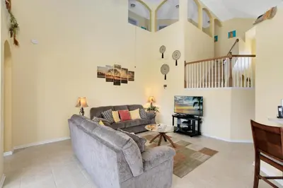 a living room with a couch and a table at Fantastic Resort 5BR House - South Facing Pool/Spa in Kissimmee