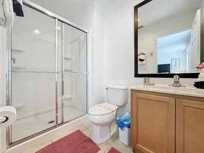 a bathroom with a shower and a toilet and a sink at Amazing Townhouse close to Disney 2 Bed 2.5 Bath in Kissimmee