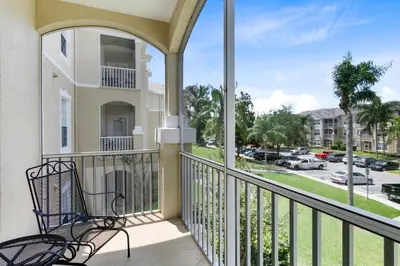 a balcony with a bench and a view of a street at Close to Disney Condo 3 Bed / 2 Bath in Kissimmee