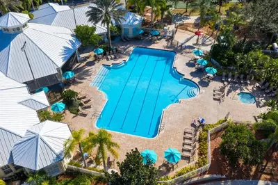 an overhead view of a swimming pool with umbrellas at Close to Disney Condo 3 Bed / 2 Bath in Kissimmee