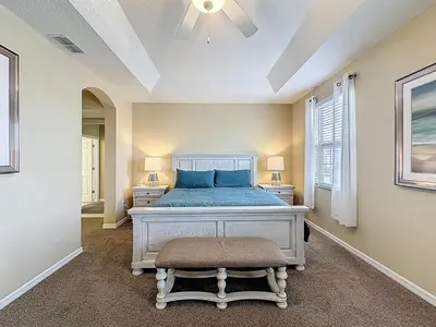 a bedroom with a bed and two night stands at Veranda Home, 8br, 6 en-suites, Lake View,POOL/SPA in Kissimmee