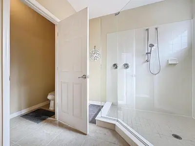 a bathroom with a shower and a toilet at Veranda Home, 8br, 6 en-suites, Lake View,POOL/SPA in Kissimmee