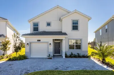 a white house with a garage at Five bedroom home is ideal for an elegant vacation in Kissimmee