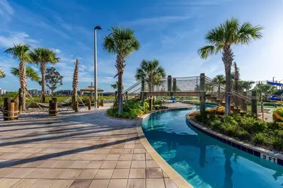 a swimming pool with palm trees and a bridge at Five bedroom home is ideal for an elegant vacation in Kissimmee