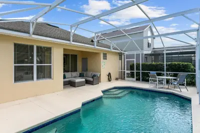 a pergola over a swimming pool in a house at South Facing Pool 4 Bedroom 3 Bath Villa in Kissimmee