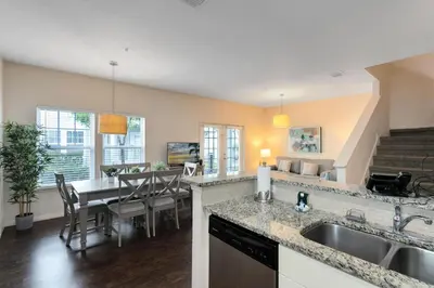 a kitchen and dining room with a sink and a table at Lucaya Village Resort - 4 Bed 3 Bath Townhouse in Kissimmee