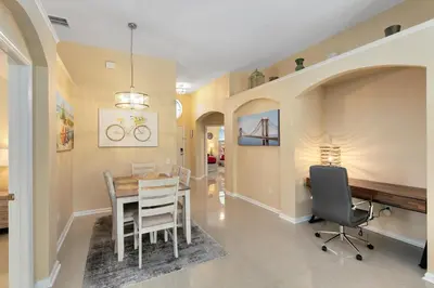 a dining room with a table and chairs at Amazing Disney Dream Getaway in Windsor Palms! in Kissimmee