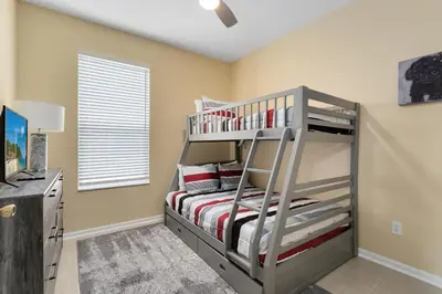 a bedroom with a bunk bed in a room at Amazing Disney Dream Getaway in Windsor Palms! in Kissimmee