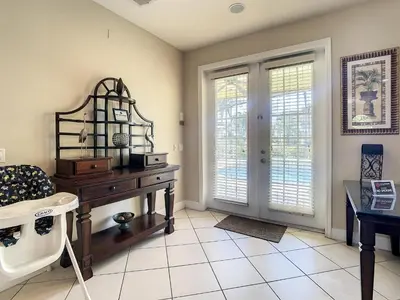 a living room with a desk and a window at Fantastic 7 Bed 6 Bath in Prestigious Gated Comm. in Orlando