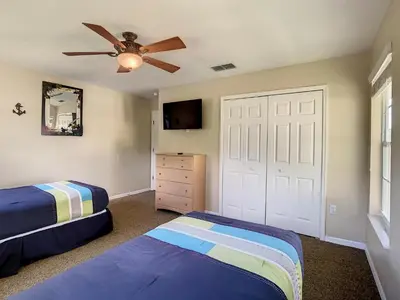a bedroom with two beds and a ceiling fan at Fantastic 7 Bed 6 Bath in Prestigious Gated Comm. in Orlando