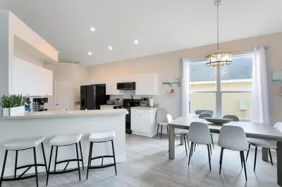 a kitchen and dining room with a table and chairs at Amazing 6 Bed Disney Dream Getaway in Windsor Palm in Kissimmee