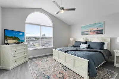 a bedroom with a bed and a ceiling fan at Amazing 6 Bed Disney Dream Getaway in Windsor Palm in Kissimmee
