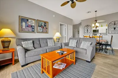 a living room with a couch and a table at Making Memories Resort Windsor Palms Condo in Kissimmee