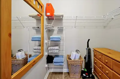 a walk in closet with towels and a shelf at Making Memories Resort Windsor Palms Condo in Kissimmee