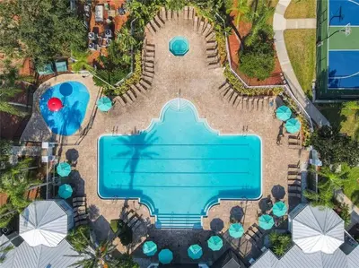 an overhead view of a swimming pool with tables and chairs at Making Memories Resort Windsor Palms Condo in Kissimmee