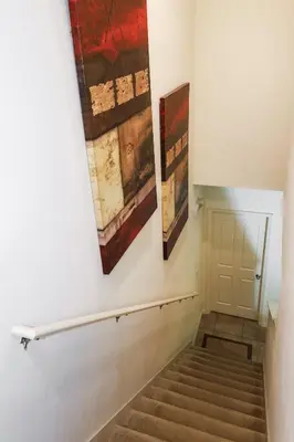 a staircase with three paintings on the wall at Amazing 4 bedroom house near Disney in Kissimmee