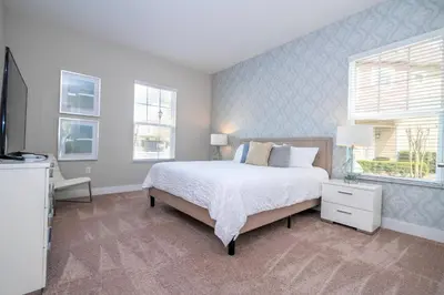 a bedroom with a large bed and a window at 5 Min to Disney Dream 5 Suites Villa in Orlando
