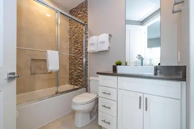 a bathroom with a toilet and a sink and a shower at 5 Min to Disney Dream 5 Suites Villa in Orlando