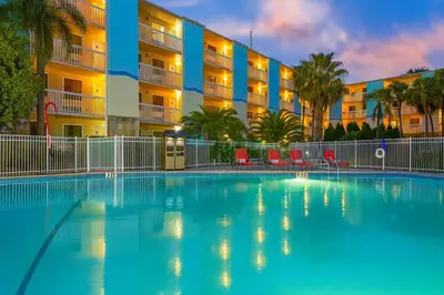 a swimming pool in front of a apartment building at Orlando International Drive North Hotel in Orlando