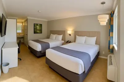 a hotel room with two beds and a television at Orlando International Drive North Hotel in Orlando