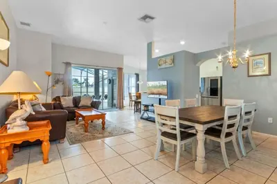 a living room with a table and a dining room at 3Br 2Ba Private Pool Villa just steps away from villa in Kissimmee