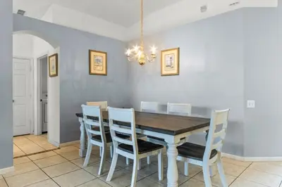 a dining room with a wooden table and chairs at 3Br 2Ba Private Pool Villa just steps away from villa in Kissimmee