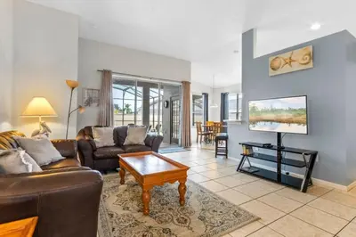 a living room with a couch and a table at 3Br 2Ba Private Pool Villa just steps away from villa in Kissimmee