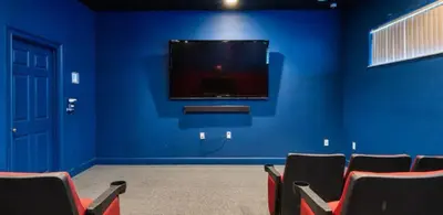 a room with a blue wall with a flat screen tv at Zen Escape At Terra Verde By Shine Villas in Kissimmee