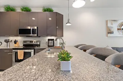 a kitchen with a granite counter top with a sink at Priceless Peace At Serenity By Shine Villas 081 in Orlando