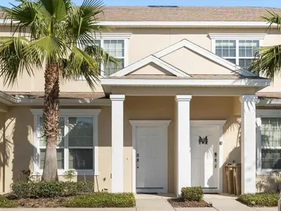 a house with a palm tree in front of it at Priceless Peace At Serenity By Shine Villas 081 in Orlando