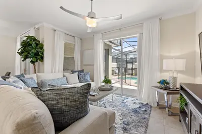 a living room with a couch and a ceiling fan at Plush Pelican, At Storey Lake By Shine Villas #839 in Kissimmee