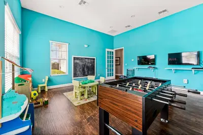 a room with blue walls and a pool table at Lucky Find Lucaya Resort By Shine Villas 713 in Kissimmee