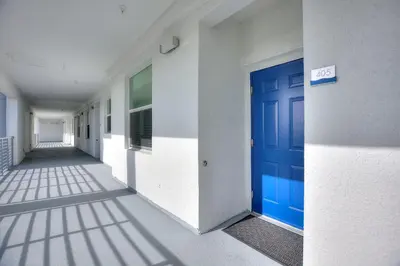 an empty hallway with a blue door in a building at Fireworks Night -Storey Lake By Shine Villas #709 in Kissimmee