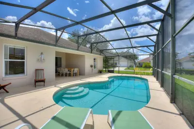 a swimming pool in a house with a glass roof at Gilded Parasol By Shine Villas Remington Golf 420 in Kissimmee
