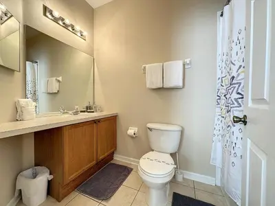 a bathroom with a toilet and a sink at Luxury 6BD 3.5BA Pool Home in Windsor Palms Resort in Kissimmee