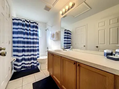 a bathroom with a sink and a toilet and a shower at Luxury 6BD 3.5BA Pool Home in Windsor Palms Resort in Kissimmee