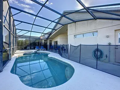 an indoor swimming pool with a glass ceiling at Emerald Island 4 bed mins to Disney in Kissimmee