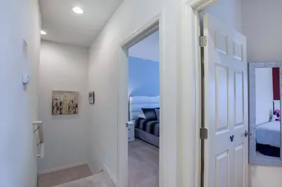 a hallway with a door leading to a bedroom at Enjoy a Cozy 3 BR/Clubhouse/Near Disney and more in Kissimmee