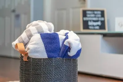 a basket filled with towels on top at Enjoy a Cozy 3 BR/Clubhouse/Near Disney and more in Kissimmee