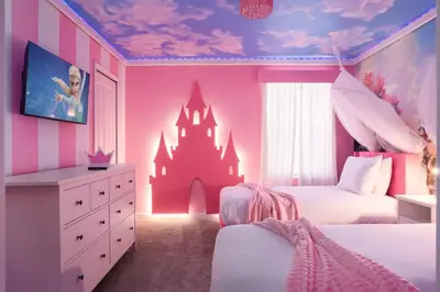 a pink bedroom with a castle on the wall at Luxury 9BR Gem- Heated Pool, Theater & Theme Rooms in Kissimmee