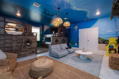 a living room with a room with a blue ceiling at Luxury 9BR Gem- Heated Pool, Theater & Theme Rooms in Kissimmee