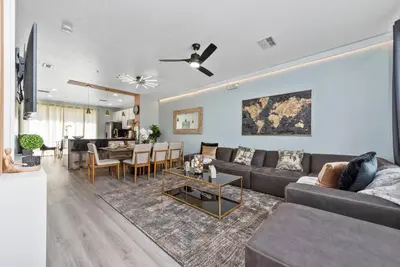 a living room with a couch and a table at Prime Location 3 Suites Townhome Near Universal in Orlando